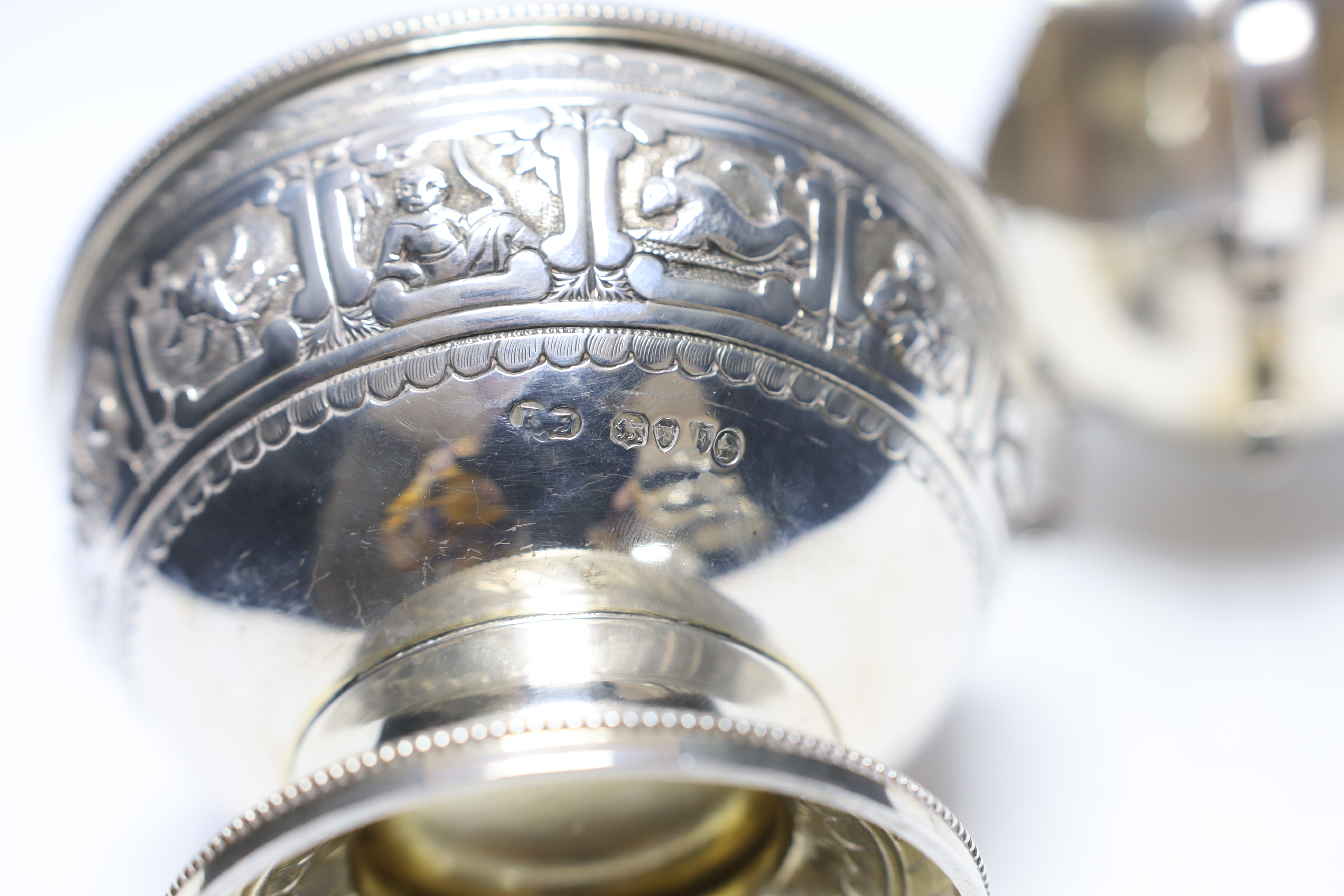 A Victorian silver 'Zodiac' pedestal bowl, by Frederick Elkington. London, 1881, diameter 12.4cm and a later silver sauceboat, 14.1oz.